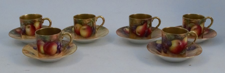 Six Royal Worcester coffee cans and saucers, decorated with fruit to a mossy background, various