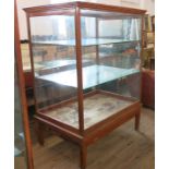 Two large glazed display cabinets, of rectangular form, with glass sides and wooden frames, each