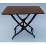 A 19th century mahogany folding coaching table, raised on a cross frame with turned supports,