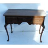 An Antique oak low boy, fitted with three drawers, raised on cabriole legs and pad feet, width 39.