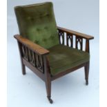 A 20th century oak framed reclining armchair, with loose upholstered cushions to the back and