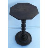 An Antique oak occasional table, the octagonal top raised on a turned column to a circular base,