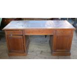 An oak partners desk, with leather inset top, fitted with three drawers over cupboards to the