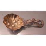 A Victorian Silver Caddy Spoon with gilt fruit embossed bowl and foliate handle, Birmingham 1853,