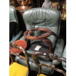 A Large Ekorness Green Leather Reclining Armchair with swing table and stool