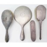 A George V Silver Backed Hand Mirror and Brush London 1915, Mappin & Webb and two other brushes