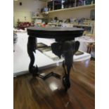An Indian Carved Ebony Occasional Table with elephant mask legs