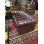 A Chesterfield Sofa in oxblood leather upholstery