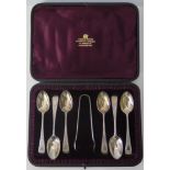 A Victorian Silver Cased Set of Six Teaspoons with sugar tongs and with bright cut decoration,