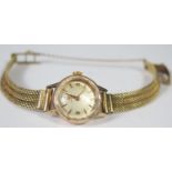 An Omega Ladies Manual Wind Wristwatch with 14ct gold strap, running, 24.8g gross