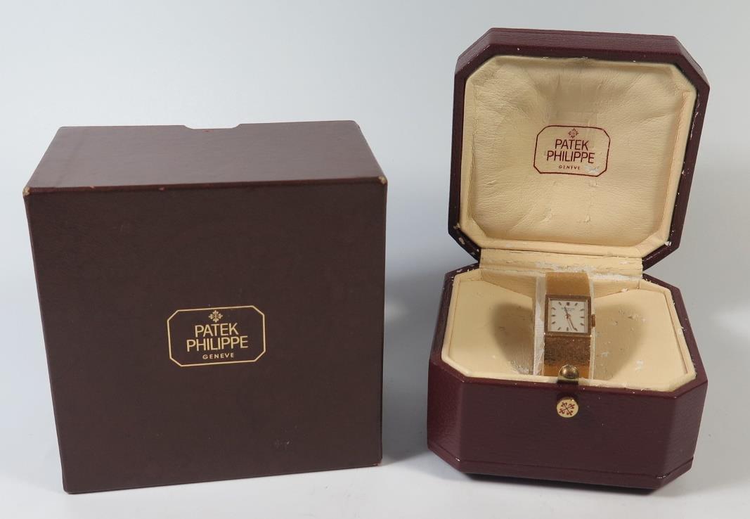 A Patek Philippe Ladies 18ctGold Wristwatch with integral bracelet, 62.2g, inner and outer box