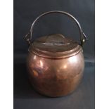 A Large 19th Century Pot Bellied Copper Boiler with iron swing handle and cover, 42cm diam. x 38cm