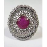 18ct White Gold Ruby and Diamond ring featuring centre, oval cut, medium red Ruby (1.23ct), colour/