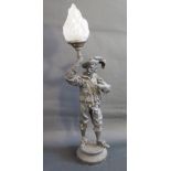 A Large Spelter Figural Table Lamp in the form of a cavalier holding a flaming torch with glass