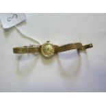 An Omega Ladies Manual Wind Wristwatch with 14ct gold strap, running, 24.8g gross