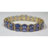 14ct Yellow Gold Tanzanite and Diamond bracelet featuring, 38 oval cut, violet blue Tanzanites (31.