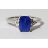 18ct White Gold Tanzanite and Diamond ring featuring centre, cushion cut, dark violet blue Tanzanite