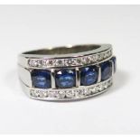 18ct White Gold Sapphire and Diamond set ring featuring, 5 oval cut, intense royal blue natural