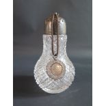 A Silver Mounted Cut Glass Sugar Shaker and silver medallion