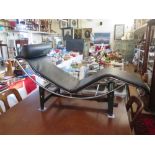 An LC4 Chaise Longue with chrome and black base and black ;leather upholstery, designed by Le