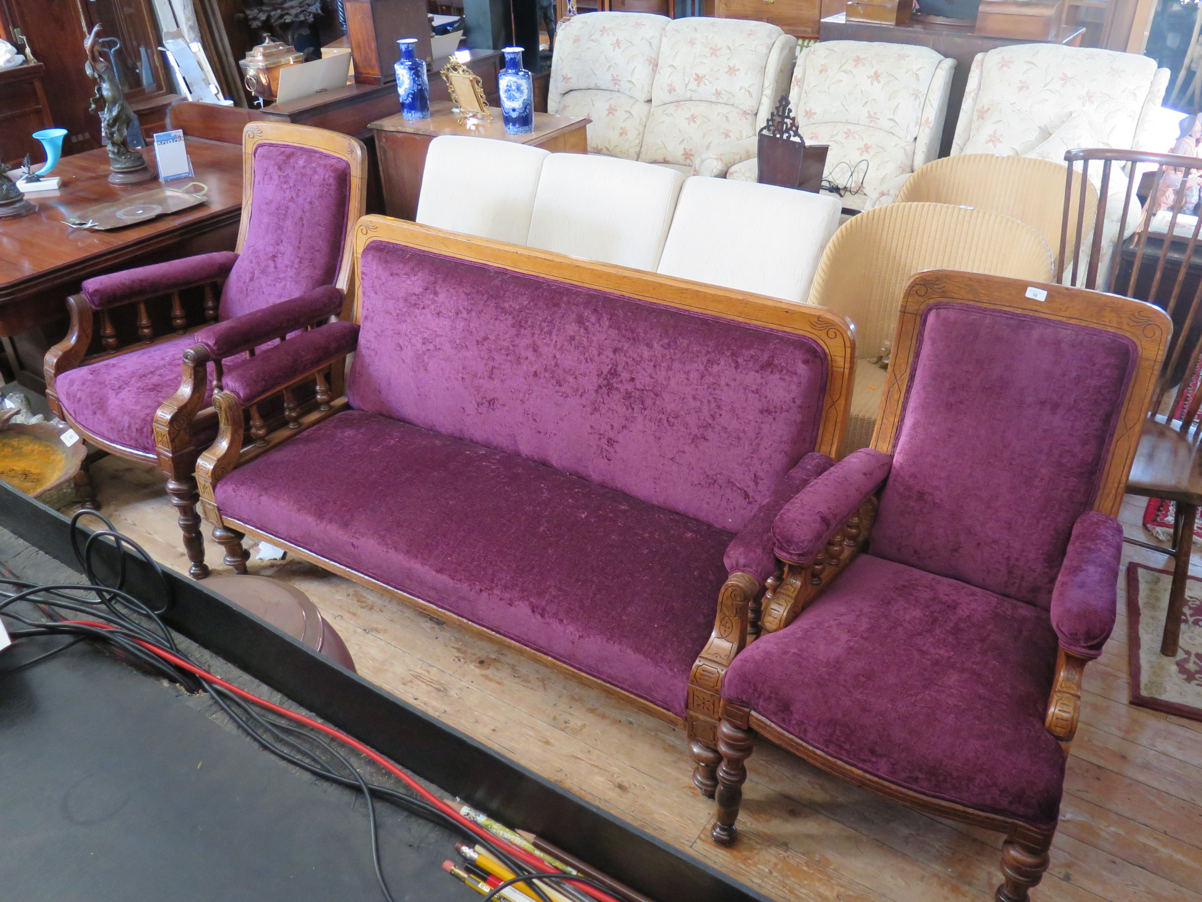 A Victorian Oak Three Piece Salon Suite in new purple plush upholstery and stool (matches previous