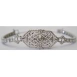 Vintage Platinum Diamond bracelet featuring centre, round brilliant cut Diamond (0.43ct), bezel set,