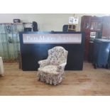 A Victorian Button Back Upholstered Armchair with ebonised legs