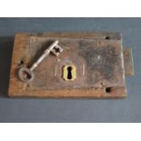 A Large Georgian Lock Plate with brass escutcheon and key in oak mount, 28 x 17cm