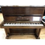 Steinway (c1888) An upright piano with a mahogany front panel.