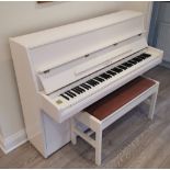 Samick (c1998) AMENDMENT (c1993) A modern style upright piano in a bright white case;