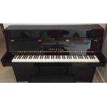 Yamaha (c2007) An upright piano in a bright ebonised case; together with a stool.