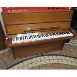 Knight (c1975) A Model K10 upright piano in a satin figured walnut case.