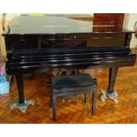 Astor A recent 6ft 1in Model G-86 grand piano in a bright ebonised case on square tapered legs;