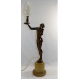 An Art Deco bronzed spelter lamp in the form of a semi-naked lady holding aloft the light in the