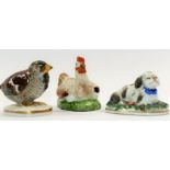 A small 19th century porcelain figure of a sparrow chick on circular base with Chelsea style gold