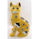 A Wemyss Ware style pottery cat by Griselda Hill, with glass eyes, potters signature to base, 33.