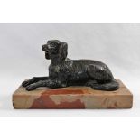 A 20th century patinated bronze figure of a spaniel lying down, with ears cocked,