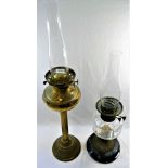 A Victorian brass oil lamp with reeded column, and another oil lamp with panel cut glass reservoir,