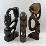 A collection of nine African carvings and sculptures including a pair of masks and a wooden club,