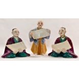 Three 19th century Worcester porcelain menu holders in the form of oriental figures holding scrolls,