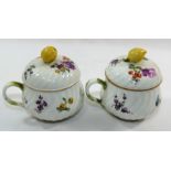 A pair of 19th century Meissen porcelain custard cups and lids, hand painted with floral sprays,