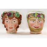 Two 18th century Derby porcelain Bacchus head mugs, of a young Bacchus and a bearded Bacchus,