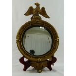 A small 19th century gilt framed convex mirror with ball shot frame and eagle surmount,