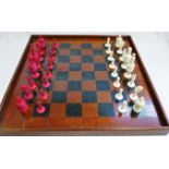 A 19th century turned and stained carved ivory and bone chess set, the tallest piece 9.