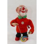 A Max Carl West German clockwork clown with spinning disc on a rope, with factory monkey label,