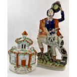 A 19th century Staffordshire flatback figure of a Scottish huntsman with deer over his shoulder,