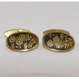 A pair of yellow metal and niello oval c