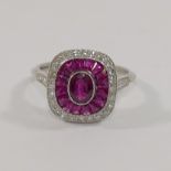 A ruby and diamond cushion-shaped target cluster ring,