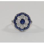 A sapphire and diamond oval flower head target cluster ring,