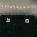 A pair of diamond stud earrings, the round brilliant cut diamonds approximately 0.
